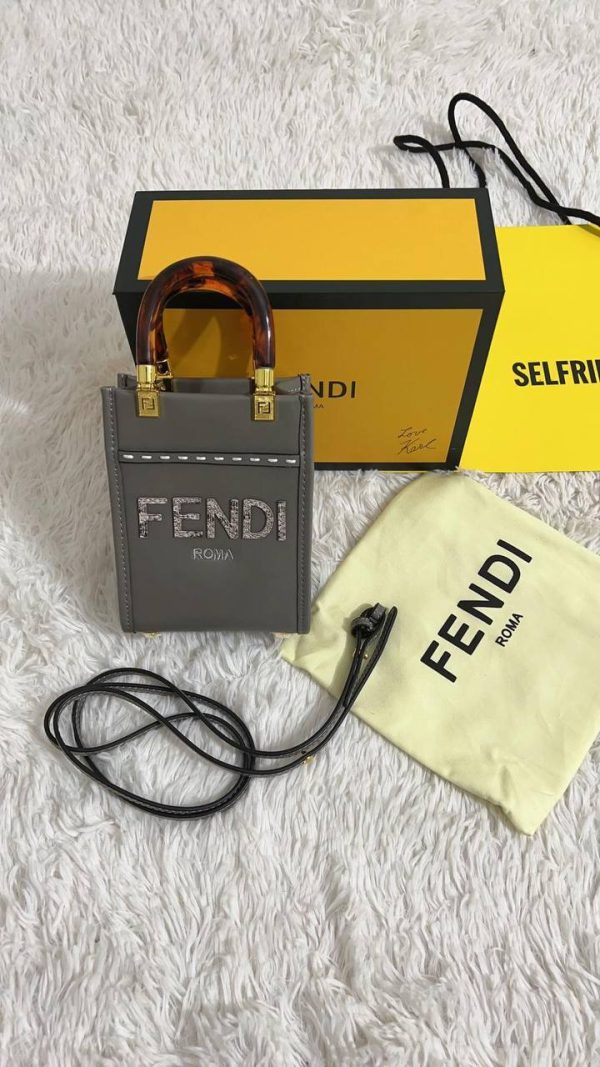 Front view of Fendi Sunshine Mini Tote in dove grey leather with hot-stamped FENDI ROMA logo. Front view of Fendi Sunshine Mini Tote in dove grey leather with hot-stamped FENDI ROMA logo.