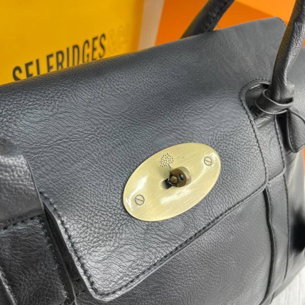 Close-up of the Mulberry logo embossing in gold on the black leather Close-up of the Mulberry logo embossing in gold on the black leather