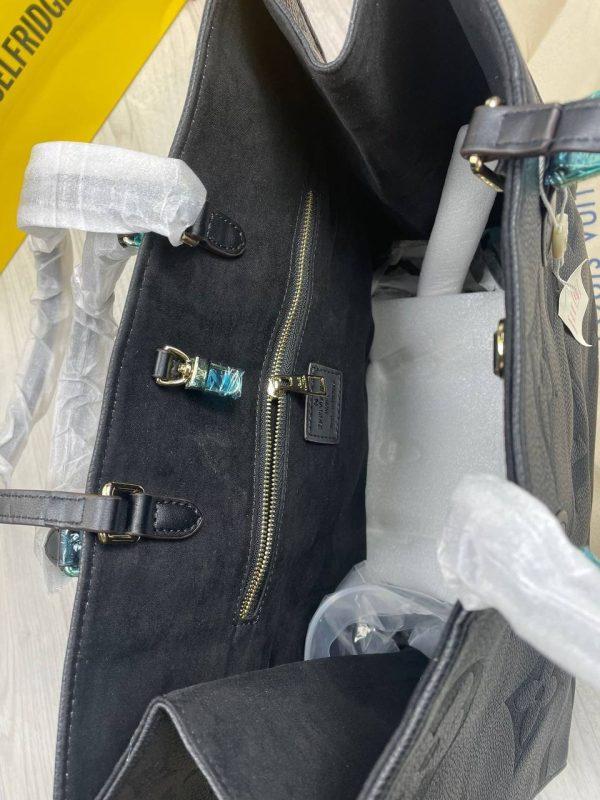 Interior view of the LV On The Go Tote Bag with organized compartments and branded lining. Interior view of the LV On The Go Tote Bag with organized compartments and branded lining.