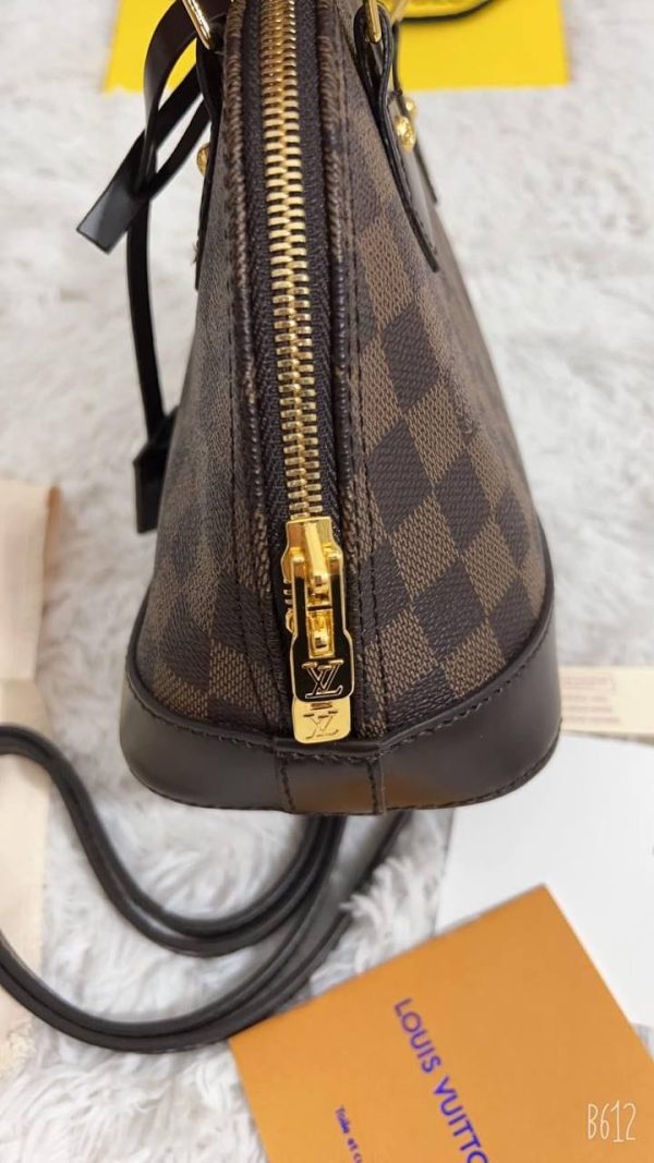 Side view showcasing the sleek zipper and polished stitching of the designer inspired Alma crossbody bag Side view showcasing the sleek zipper and polished stitching of the designer inspired Alma crossbody bag