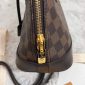 Side view showcasing the sleek zipper and polished stitching of the designer inspired Alma crossbody bag