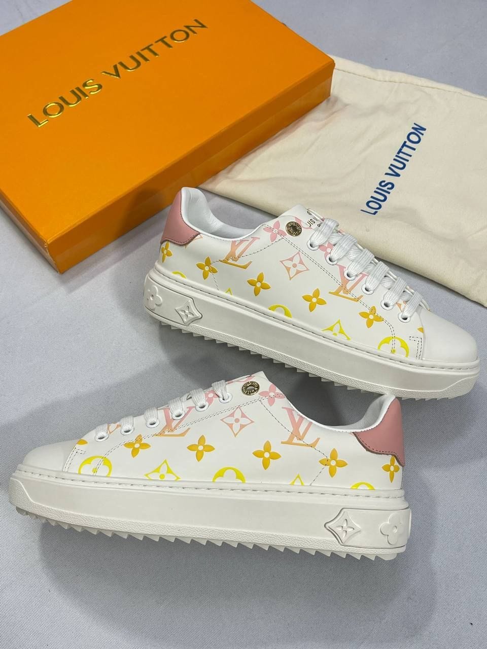 Louis Vuitton Monogram Debossed Time Out Leather Women's white with yellow logo Trainers