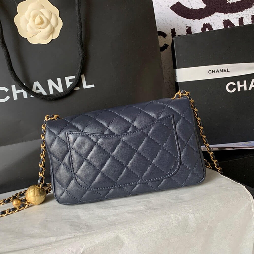 Back view of navy Chanel mini flap bag with slip pocket