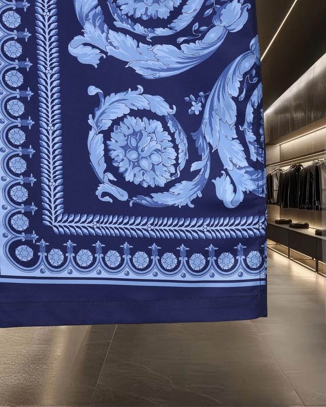 Border print at the hem of navy blue Versace shirt close view