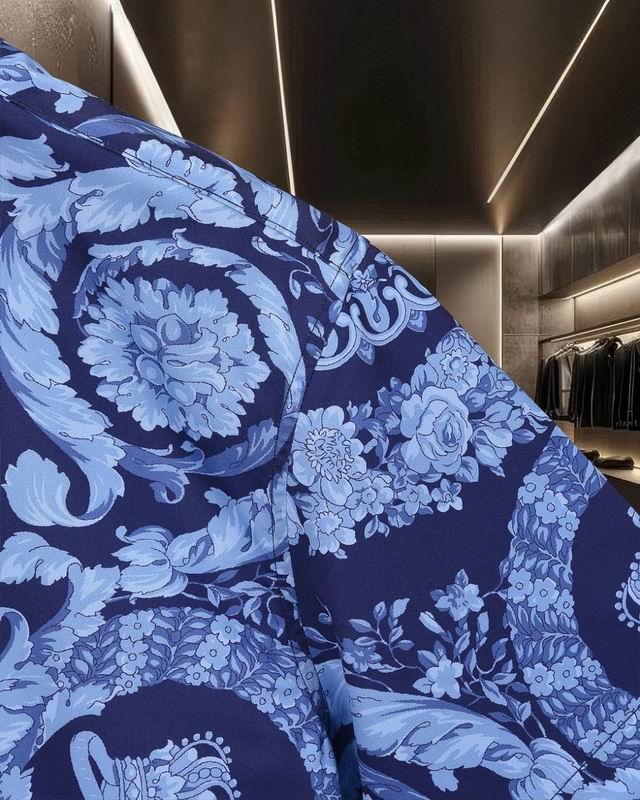 Close view of Versace shirt shoulder with blue baroque flower print
