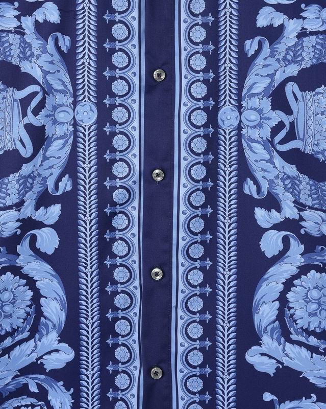 Dark buttons and border print close view on blue Versace shirt