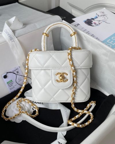 Fake Chanel vanity case bag in white with top handle and gold chain front view