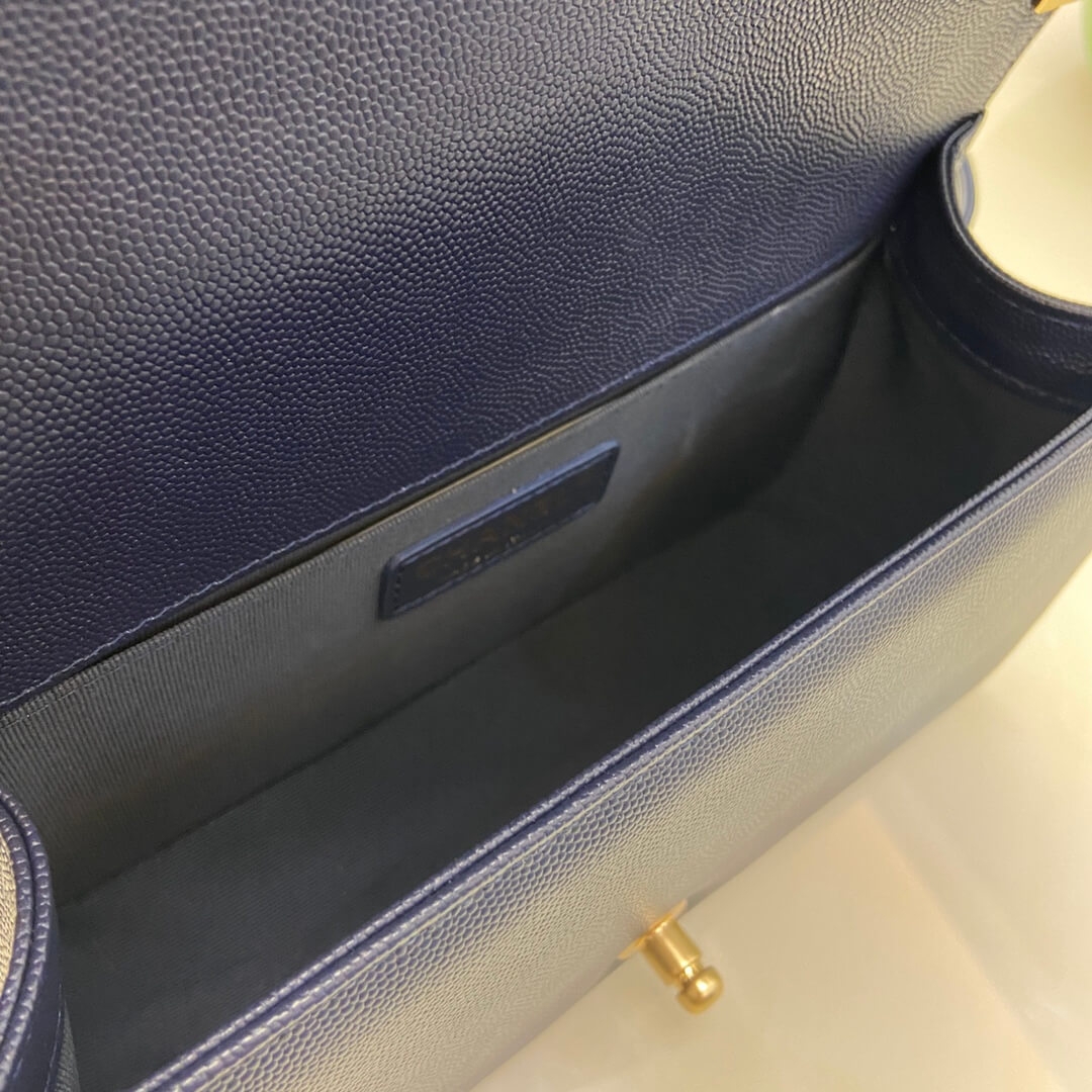 Inside view of Boy Chanel bag with dark lining and slip pocket