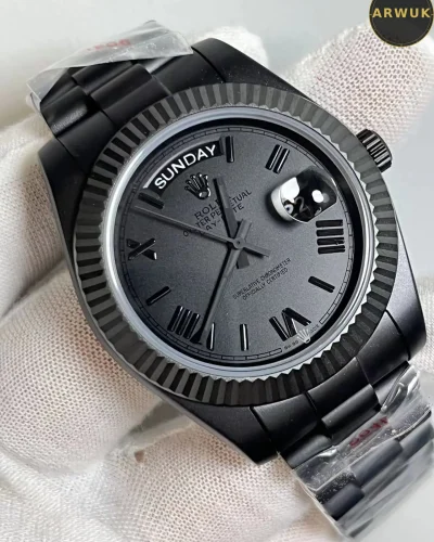 Matte black dial close view of Rolex Day-Date with day display and cyclops