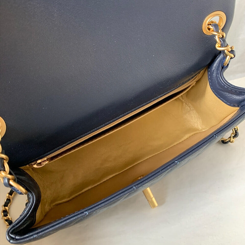 Open inside view of navy Chanel flap bag with gold