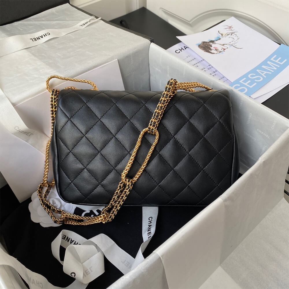 Quilted black lambskin back view of Chanel flap bag with rope chain