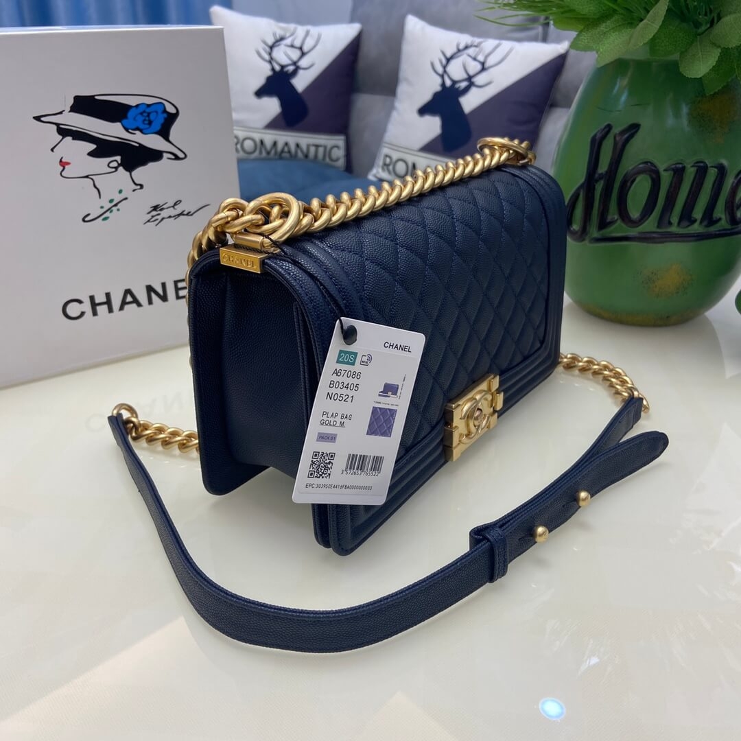 Side view of Boy Chanel bag with adjustable leather shoulder strap